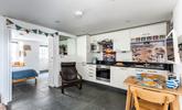 The kitchen is fully equipped with modern appliances whilst iconic images of St Ives add to its charm. - Thumbnail Image