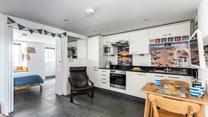 The kitchen is fully equipped with modern appliances whilst iconic images of St Ives add to its charm.