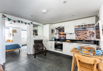 The kitchen is fully equipped with modern appliances whilst iconic images of St Ives add to its charm.
