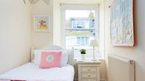 Tucked away in a quiet part of the house, this bedroom will help younger members of your party drift off.