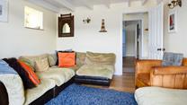 The sitting room mixes colours and textures to create a welcoming space.