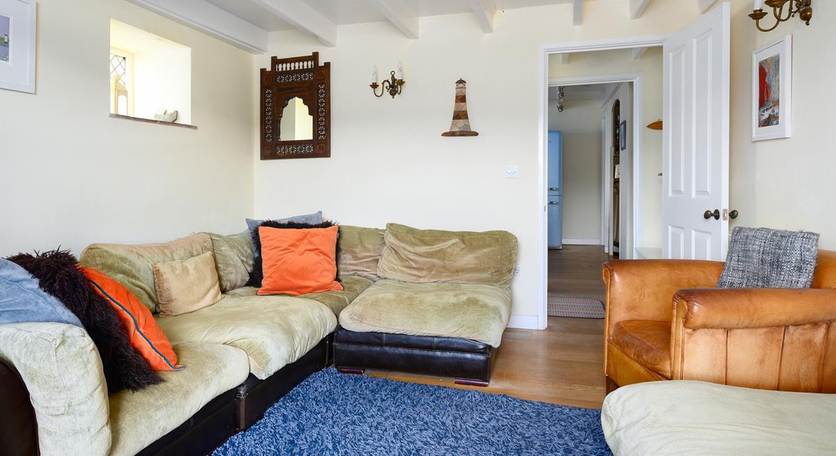 The sitting room mixes colours and textures to create a welcoming space.