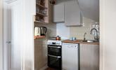 Modern appliances make cooking in this cute kitchen a breeze. - Thumbnail Image