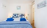The bedroom is decorated in blue seaside tones. - Thumbnail Image