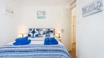 The bedroom is decorated in blue seaside tones.