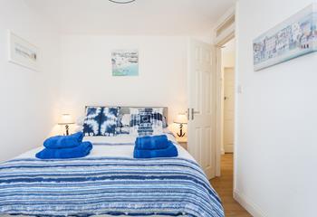 The bedroom is decorated in blue seaside tones.