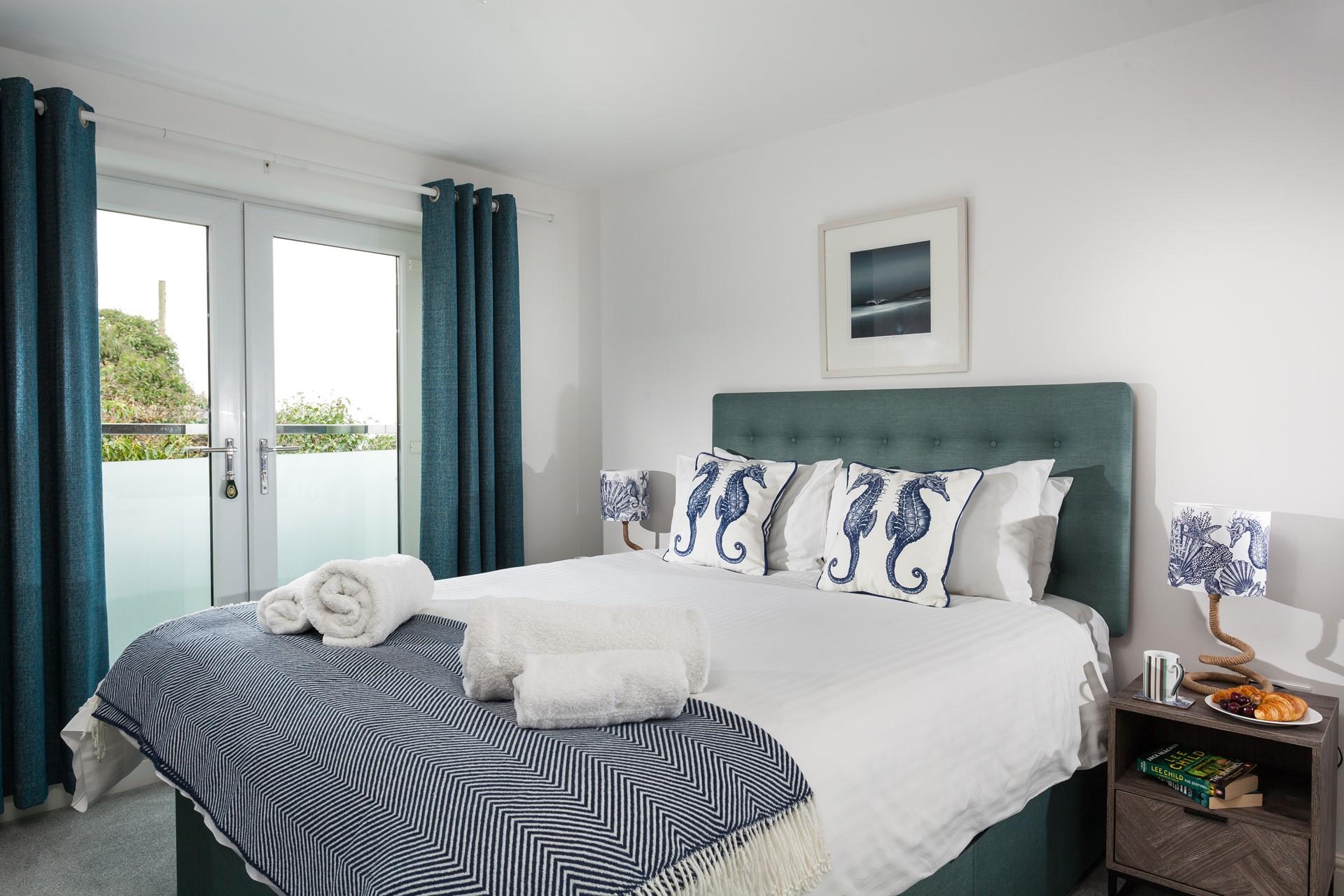 Soft sheets and fluffy towels await you in the bedroom.