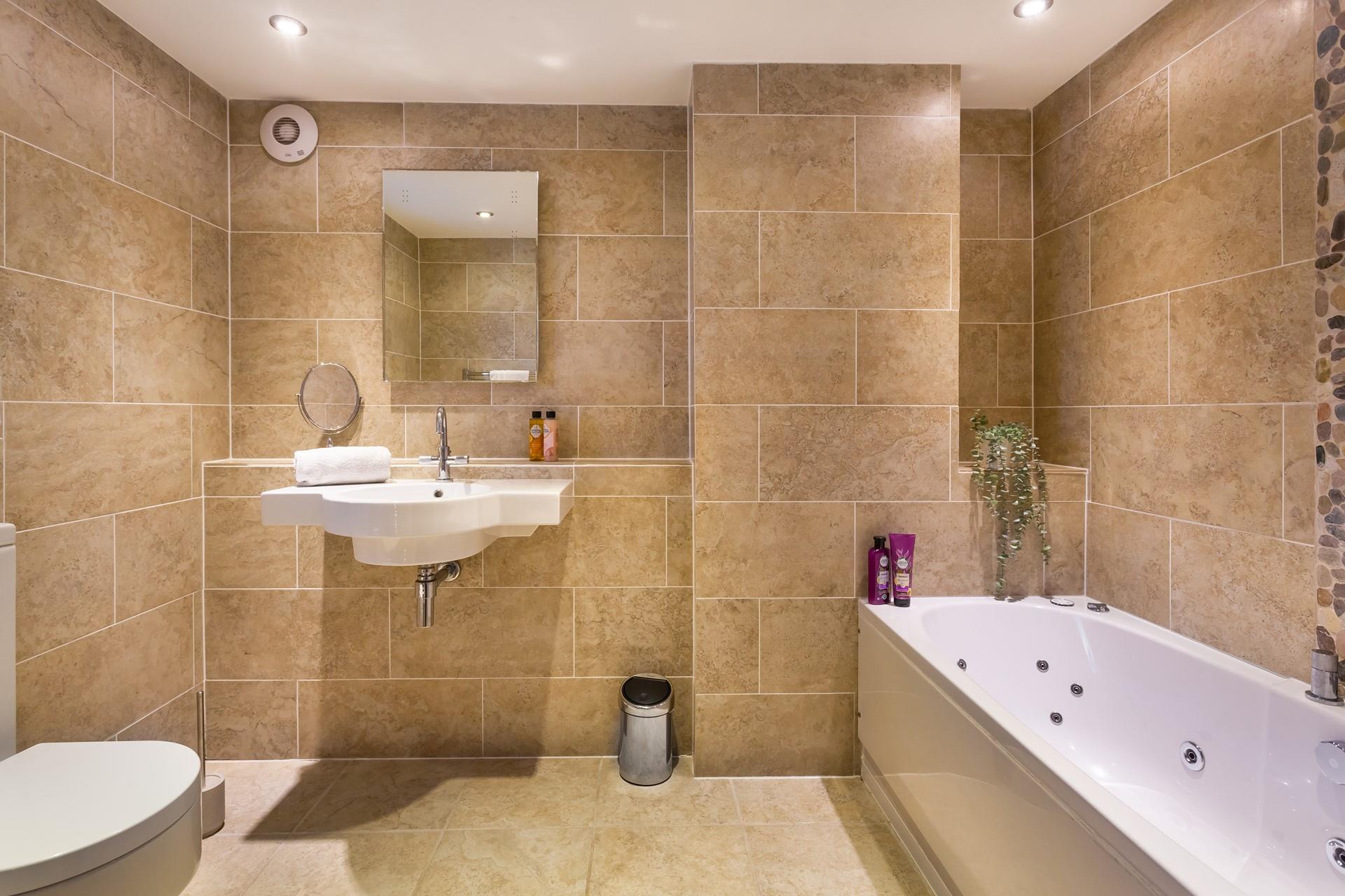 Take a soak in the bath in the modern bathroom in the evening.