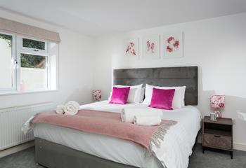 Bedroom 1 is decorated with a pop of colour and sealife artwork.