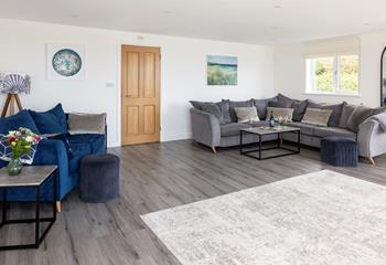 The large sitting room is perfect to spend quality time together, catching up over a glass of your favourite wine.
