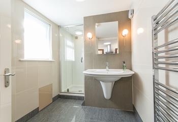 The bright and modern shower room is surprisingly spacious, perfect for starting your day in or freshening up before adventuring out for dinner.
