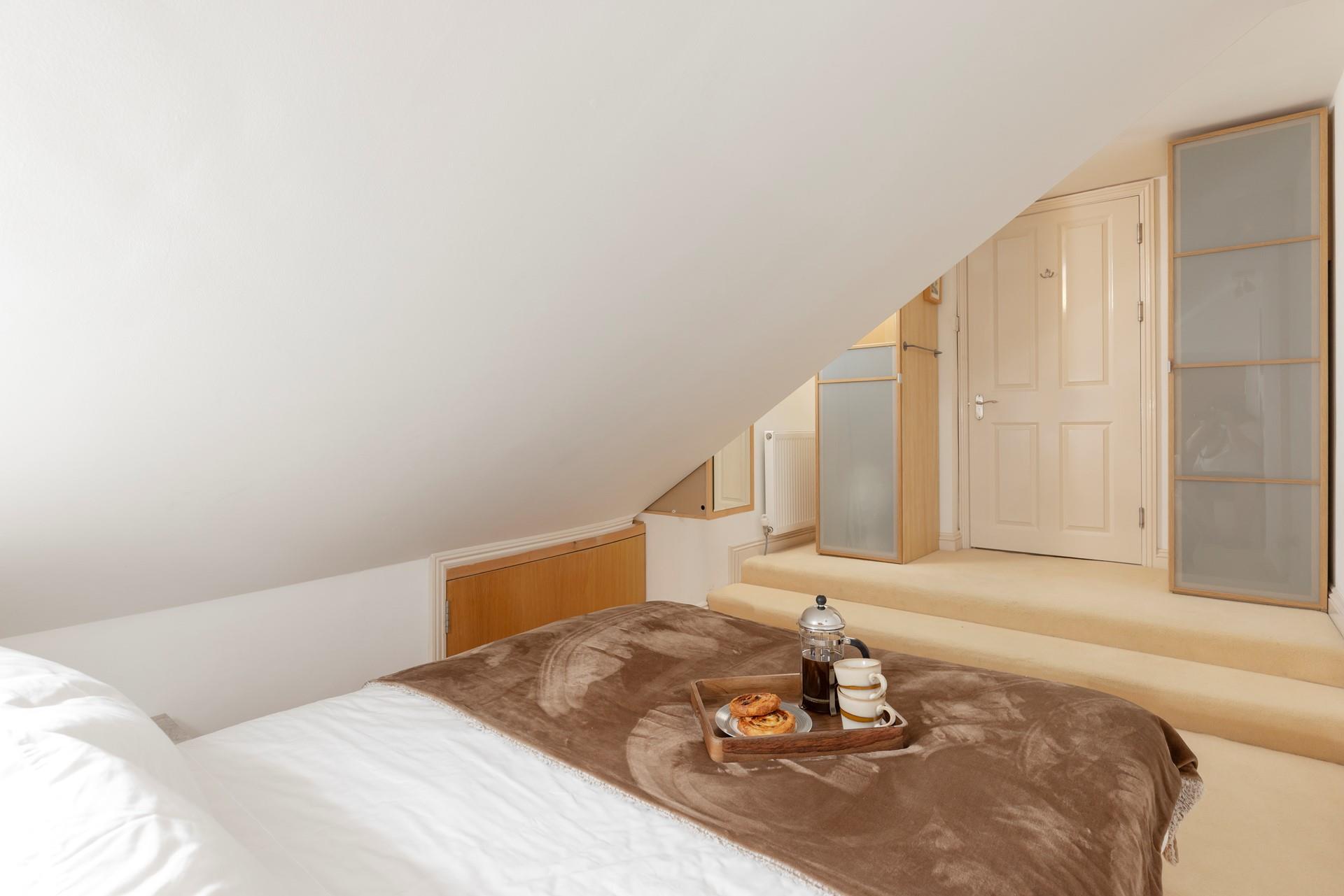 The bedroom boasts a king size bed and plenty of storage.