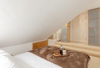 The bedroom boasts a king size bed and plenty of storage.