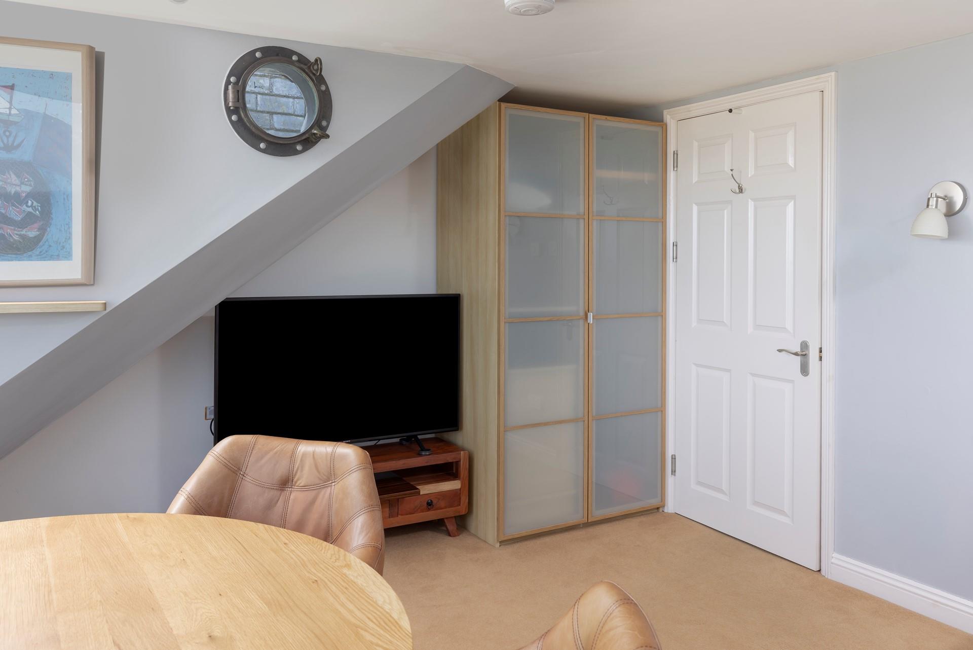 The porthole window is a quirky feature, a nod to the coastal location.