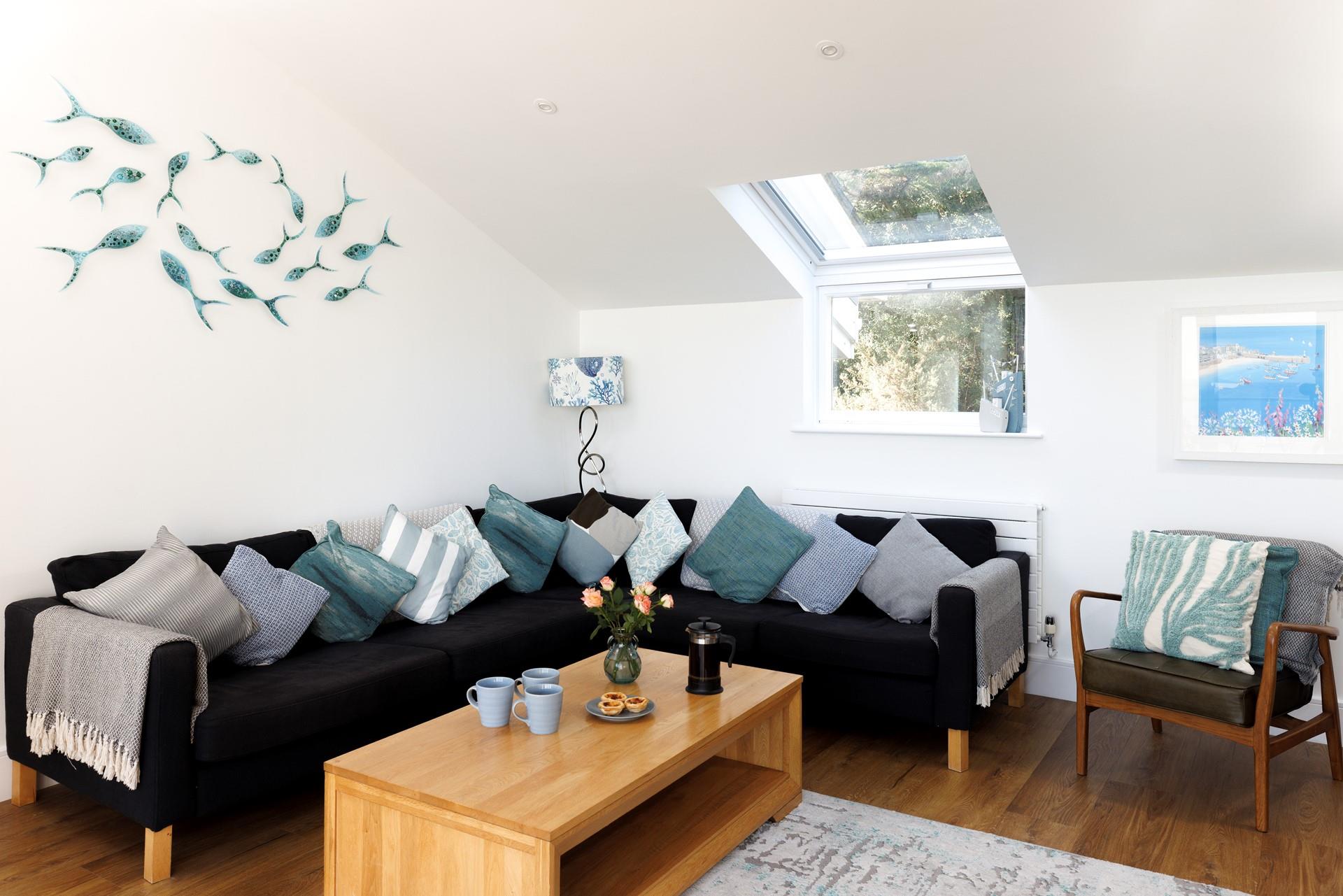 The cosy sitting room offers ample space for the whole family to come together and enjoy quality time with one another.