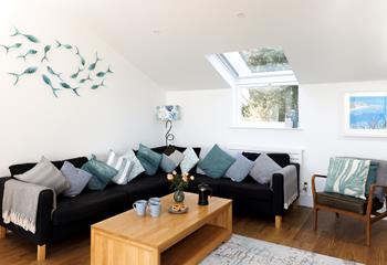 The cosy sitting room offers ample space for the whole family to come together and enjoy quality time with one another.