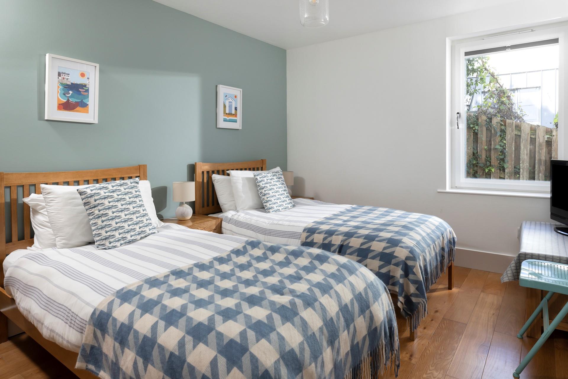 A twin bedroom with TV and fun decor makes a wonderful option for both children and teenagers.