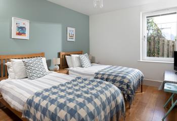 A twin bedroom with TV and fun decor makes a wonderful option for both children and teenagers.