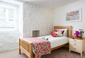 The single bedroom is bright and welcoming with quaint cottage features.