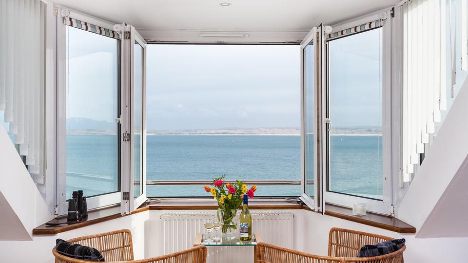 Pour yourself a glass of something chilled and kick back in the nautical themed armchairs to make the most of these incredible sea views.