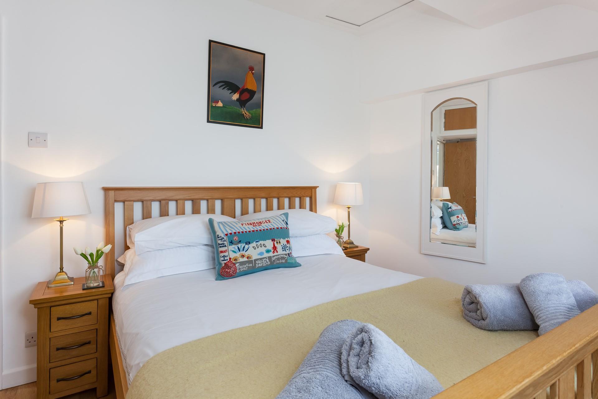 The gorgeous bedroom has a countryside feel, offering a welcoming space to relax after a busy day exploring Cornwall.