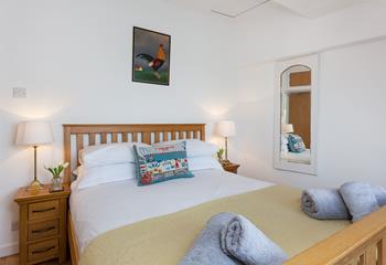 The gorgeous bedroom has a countryside feel, offering a welcoming space to relax after a busy day exploring Cornwall.