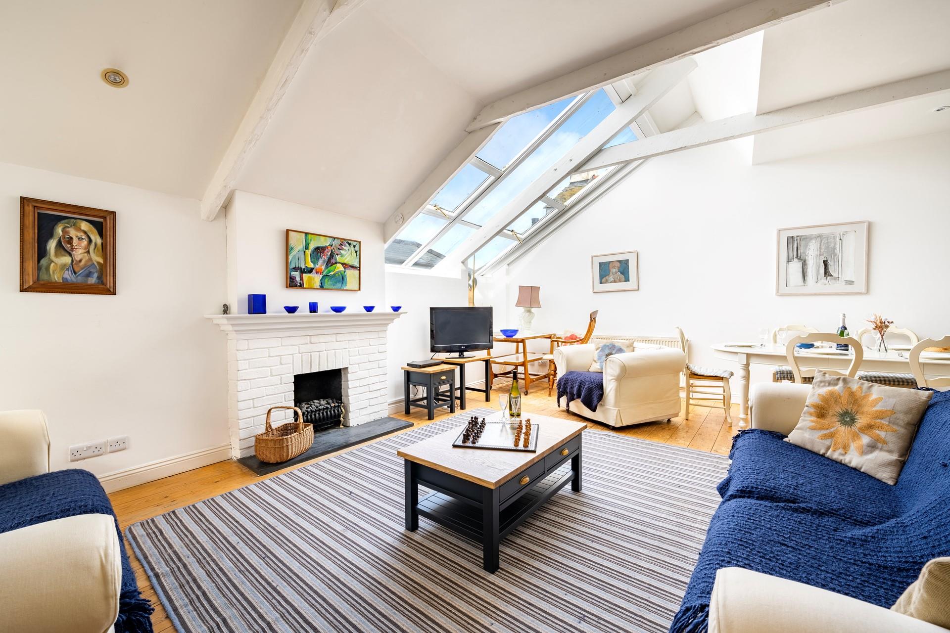 The open plan sitting/dining area is filled with light and sunshine.