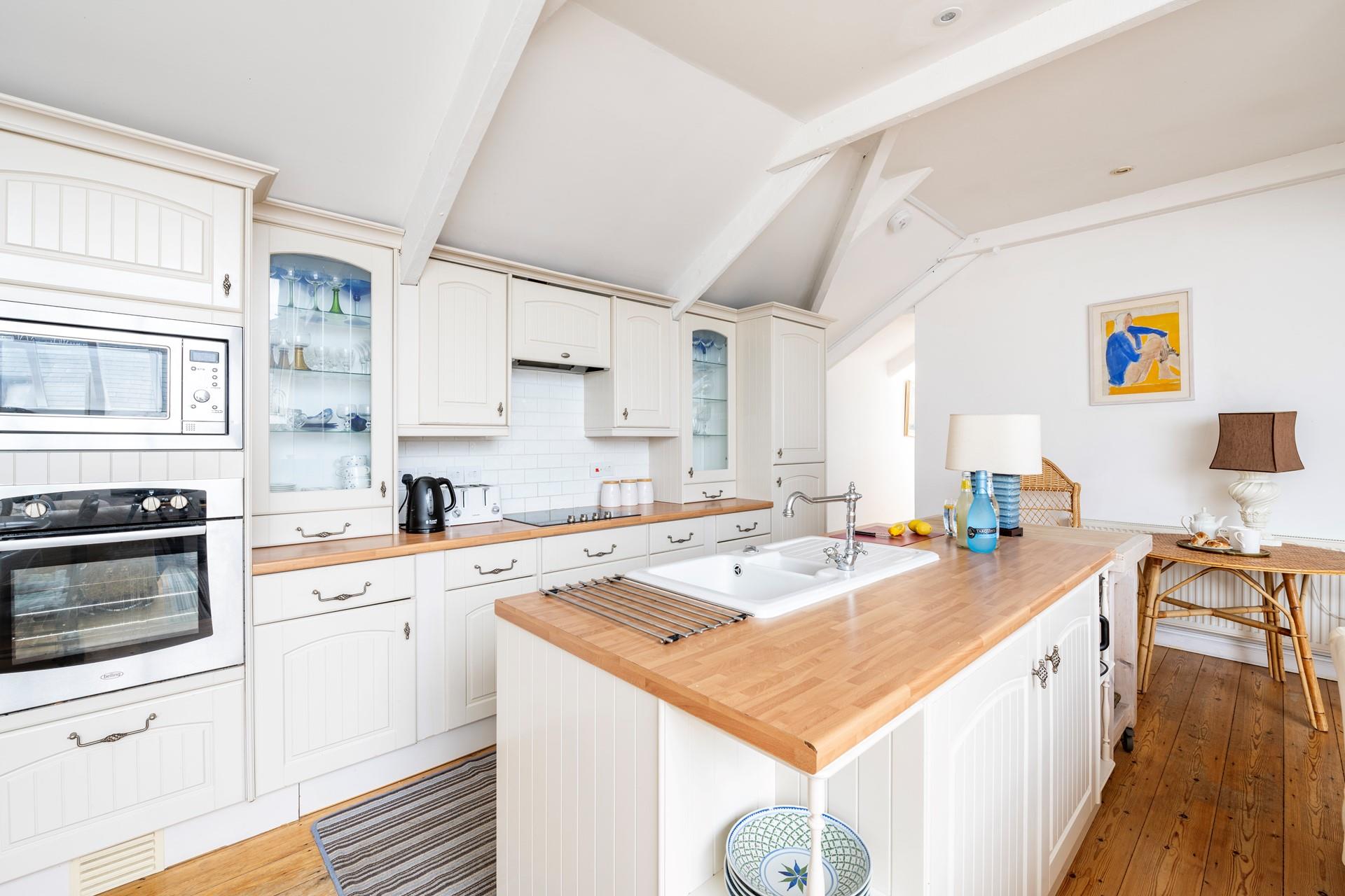 Well-equipped open plan kitchen with Island sink unit.
