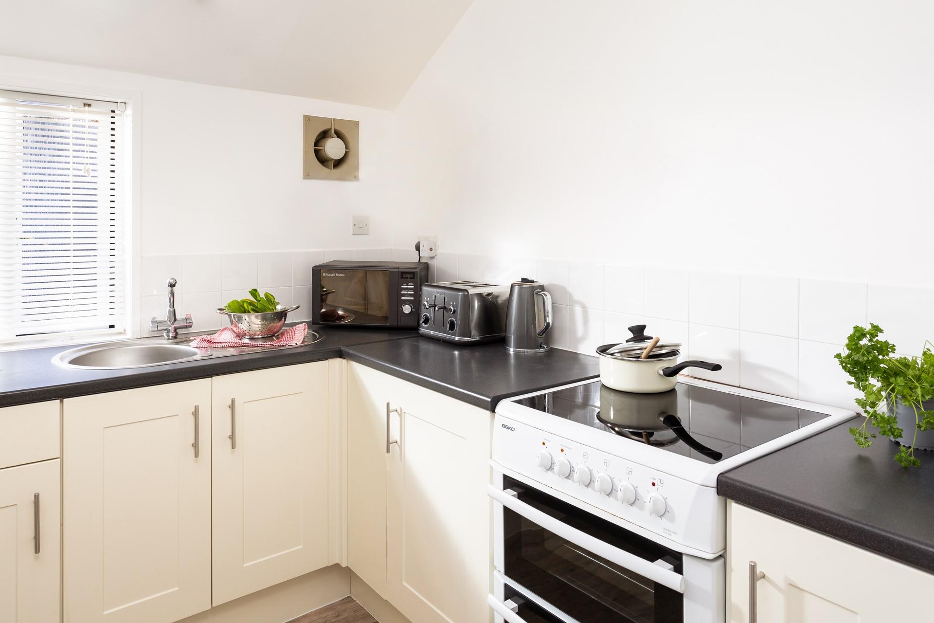 The sleek, modern kitchen is perfect for whipping up home-cooked meals.