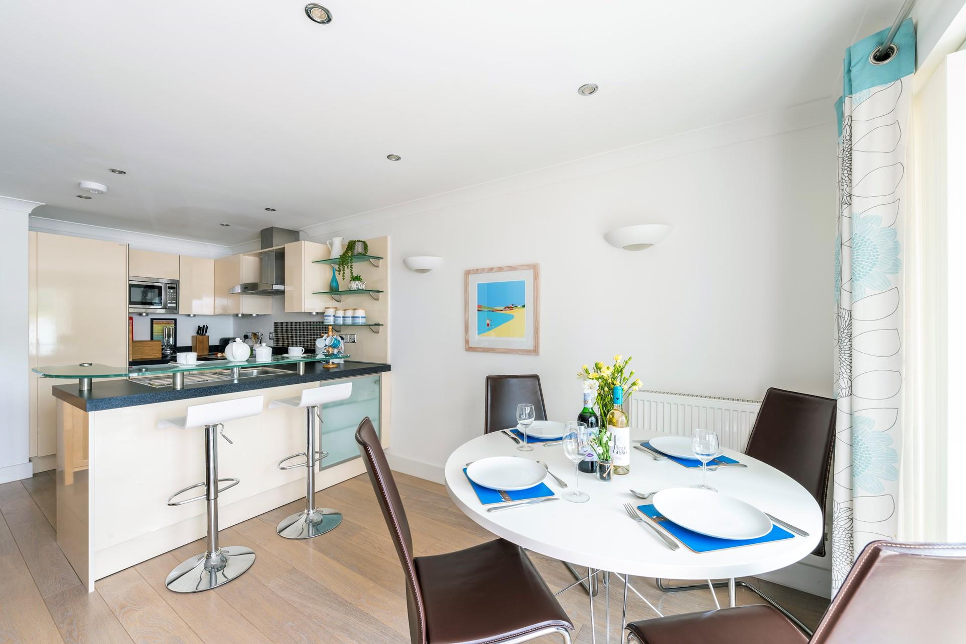 Modern kitchen with breakfast bar, fridge/freezer and dishwasher.