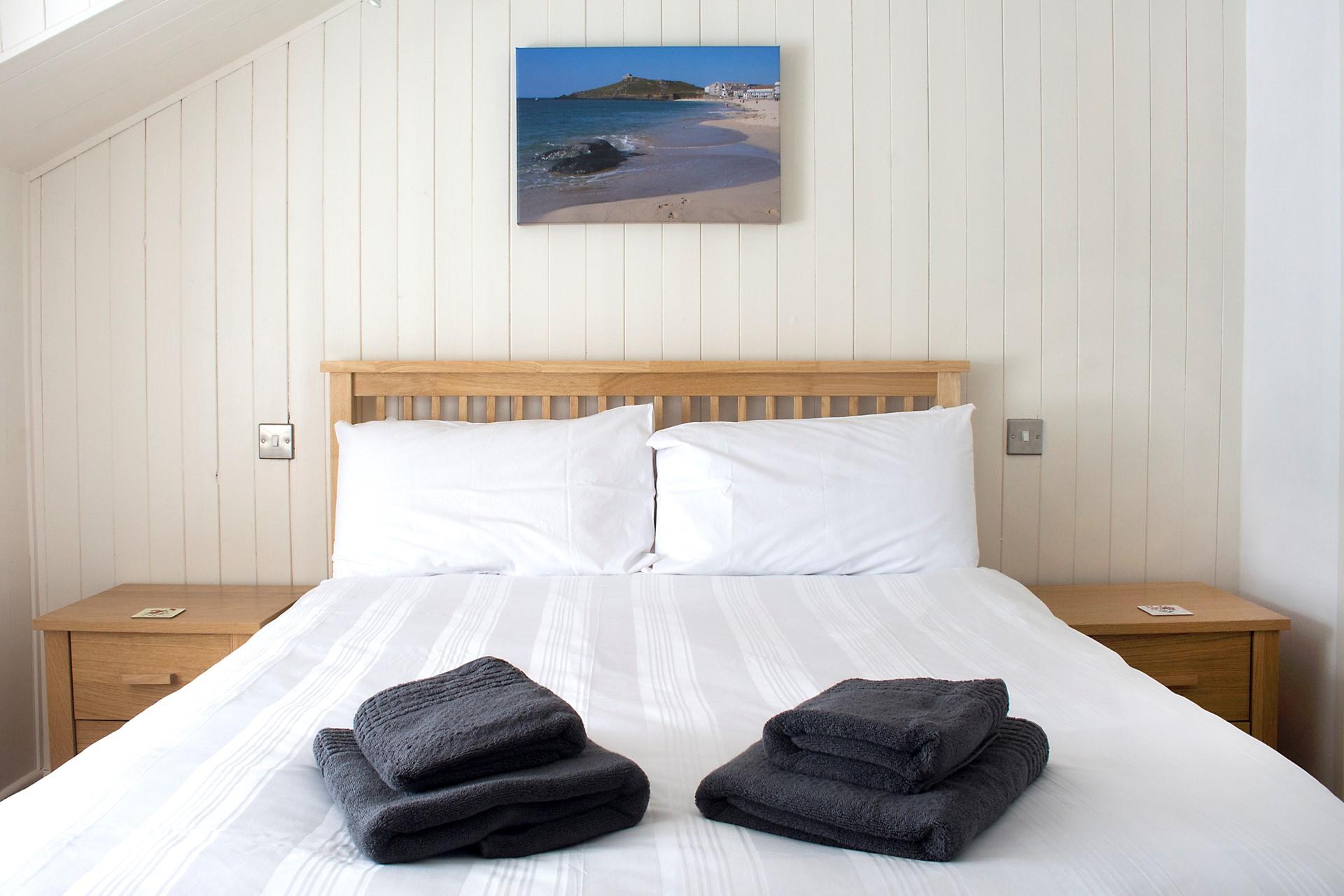 Crisp white linen invites you to snuggle down after a busy day exploring St Ives.