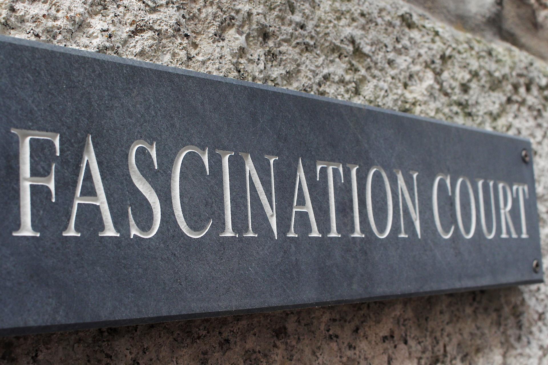 A traditional local slate sign is the perfect medium and looks great against the traditional granite stone face wall.