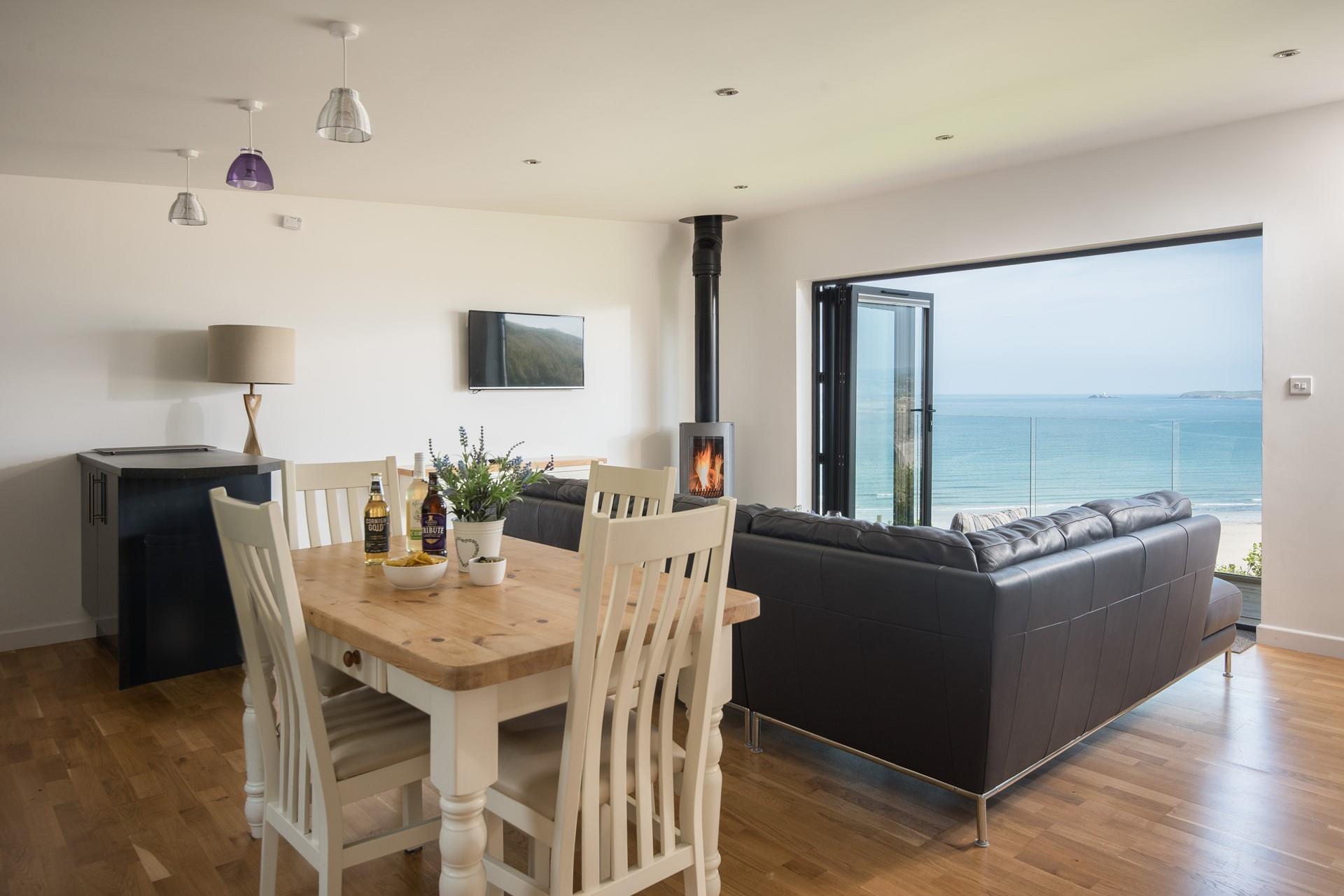 The open plan living area, designed around the feature window, allows you to take advantage of the view from every area, including the dining table. 