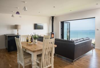 The open plan living area, designed around the feature window, allows you to take advantage of the view from every area, including the dining table. 