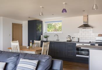 Modern and sleek, the kitchen is well-equipped and the open plan design takes advantage of those wonderful sea views. 