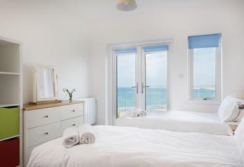 Bright and airy, the glass doors and window fill the second bedroom with natural light. At night the sunsets are divine! 