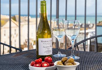 Indulge in wine and nibbles on the balcony.