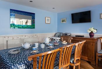 The dining area has a blue and turquoise theme reflecting the seaside location.