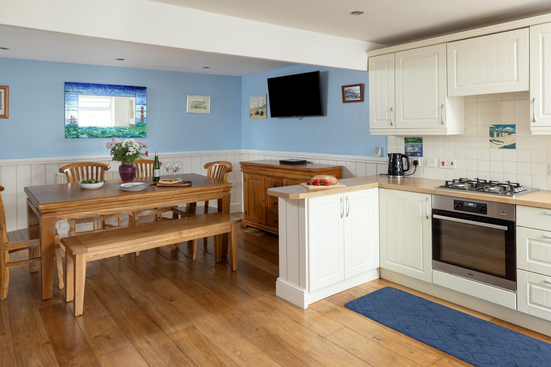 The dining area has a blue and turquoise theme reflecting the seaside location.