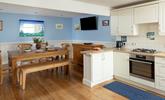 The dining area has a blue and turquoise theme reflecting the seaside location. - Thumbnail Image