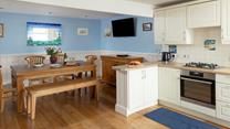 The dining area has a blue and turquoise theme reflecting the seaside location.