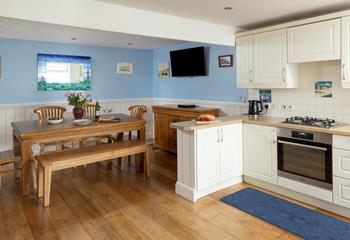 The dining area has a blue and turquoise theme reflecting the seaside location.