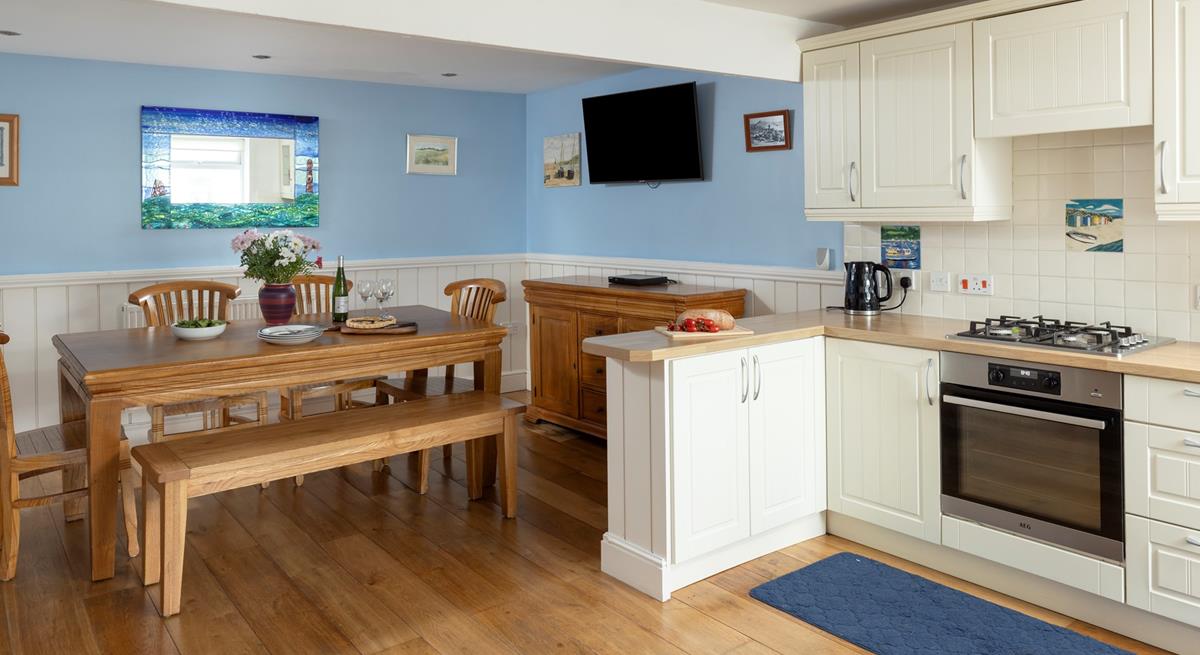 The dining area has a blue and turquoise theme reflecting the seaside location.