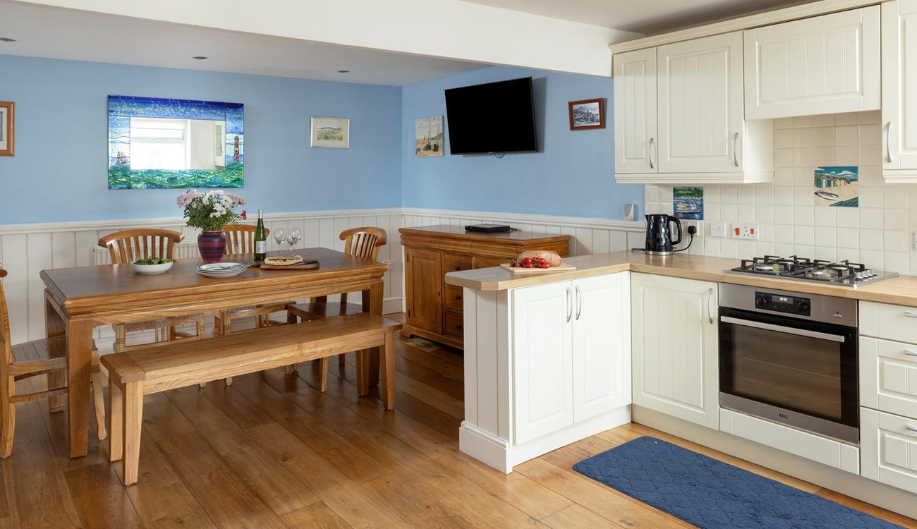 The dining area has a blue and turquoise theme reflecting the seaside location.