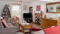 The cosy sitting room has a sofa bed for the extra guests.