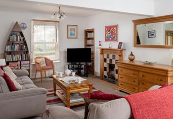 The cosy sitting room has a sofa bed for the extra guests.