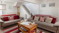 Relax in the charming sitting area after a lovely long walk along the coast.
