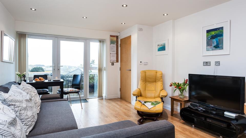 The open plan living area creates a wonderful sense of space and benefits from sea views.