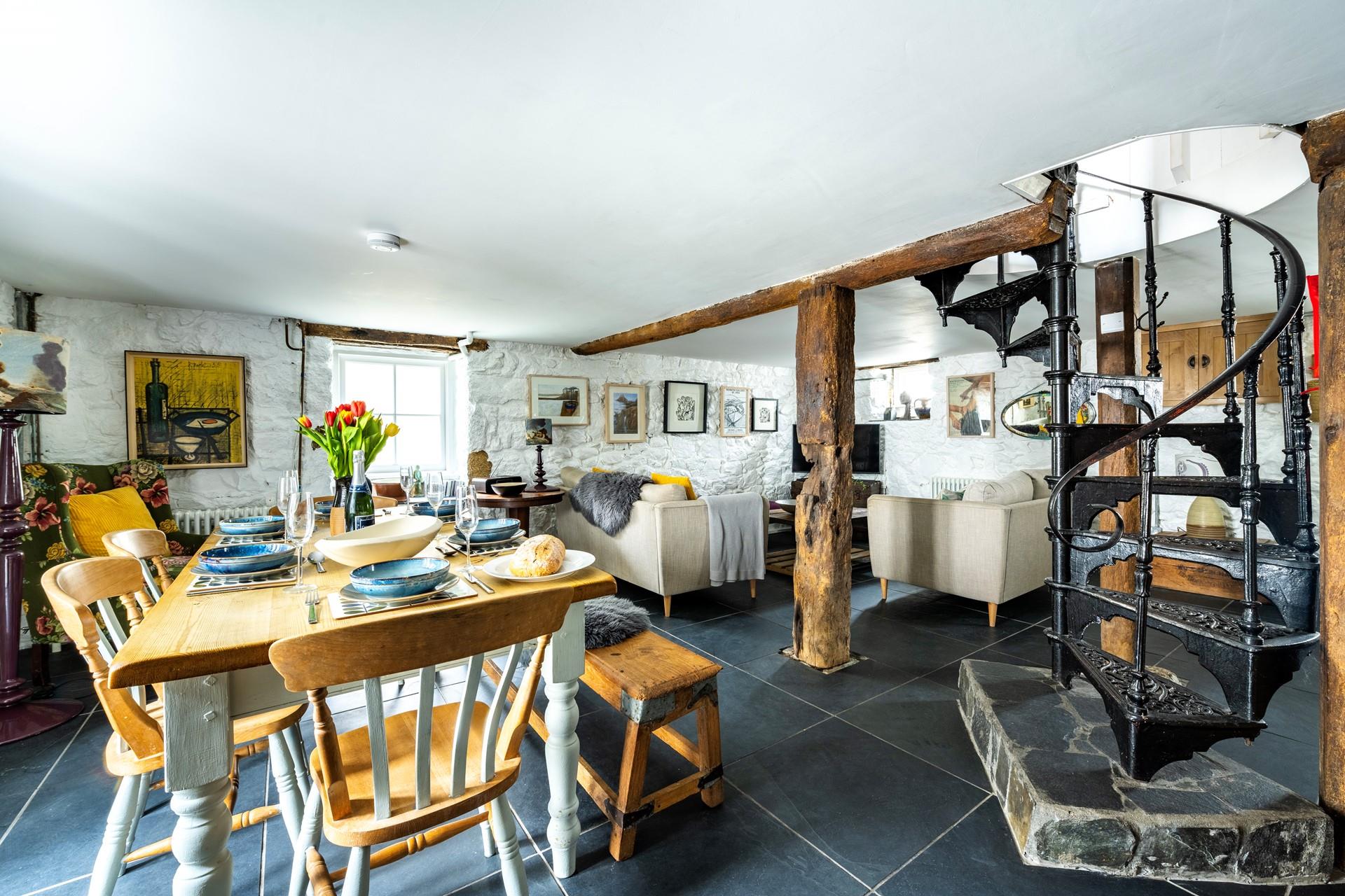 A beautiful spiral staircase leads down to the basement kitchen area.