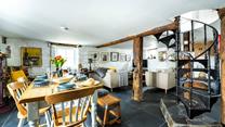 A beautiful spiral staircase leads down to the basement kitchen area.
